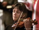 Violinist Nancy Dinovo cries while playing during a service at Christchurch Cathedral in Vancouver for the victims of...