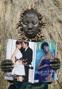 A Mursi tribe woman discovers Vogue magazine in Ethiopia.