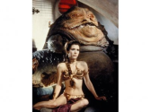 Carrie Fisher in a gold bikini chained to a fat alien.