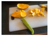 Cutting a fresh pineapple and mango