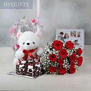 A Bunch of 12 Red Roses with Half Kg Black Forest Cake and Teddy Bear