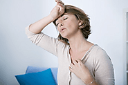 What are menopausal hot flashes and what causes them?