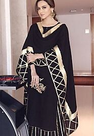 Sana Khan wears a black and gold combination suit.