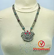 Website at https://vintarust.com/products/antique-pendant-necklace-inlaid-with-red-and-green-glass-stones