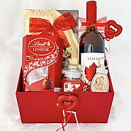 Spellbinding Valentines Day gift hamper with luscious wine, premium chocolates, scented candles and more