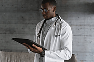 A Cardiologist is checking a patient's information