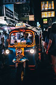 Busy Intersection with Tuk-tuks and Motorbikes in Motion