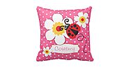 Pink polka dot throw pillow with flower and ladybug