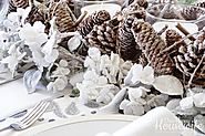 Pine cone candle holder centerpiece surrounded by frosted flowers