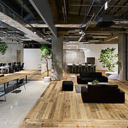 Concrete and scaffolding wood define areas at AKQA's offices