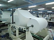 A Roll of Tissue Paper Raw Material set on machine for Production