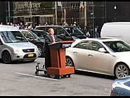 Melissa McCarthy as Sean Spicer podiums on a NYC street, May 12, 2017