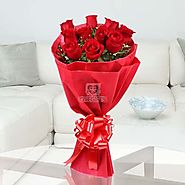 This stunning bunch of 10 Red Roses with seasonal filler wrapped beautifully in red paper - OyeGifts.com