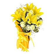 12 White Roses with 3 Yellow Lilies in Yellow Paper packing.