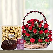A beautifully arranged basket with Red Roses and Ferrero Rocher & Cake with Spacial Greetings
