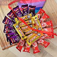 Nine KitKat Chocolates , Eight Five Star Chocolates & Eight Dairy Milk Chocolates in a basket arrangment.