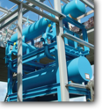 How are plate exchangers used in an ammonia refrigeration system?