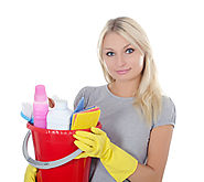 Blonde Lady with gray shirt and yellow gloves holding red bucket of cleaning supplies