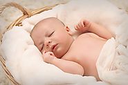 Baby sleeping on white cotton ~ Sanjeev Nanda
