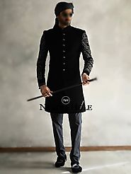 Black velvet wedding sherwani suit for groom with fancy buttons and fully embroidered sleeves